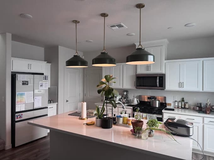 Modern kitchen with custom pendant lights installed over the island